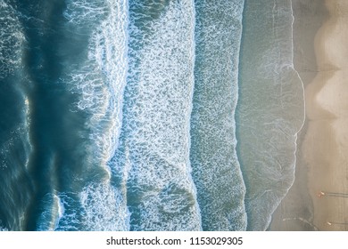 Aerial view of a beach with breaking waves