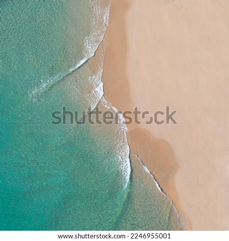 Similar – Luftaufnahme Panoramadrohne Blick auf den blauen Ozean Wellen, die am Sandstrand in Portugal erdrücken.