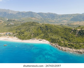 Aerial view of beach clubs along the Himare coastline part of the Albanian Riviera on the Ionian Sea in southern Albania 