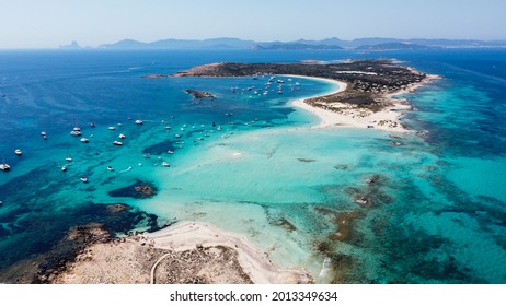Aerial view of the beaches of Ses Illetes on the island of Formentera in the Balearic Islands, Spain - Turquoise waters on both sides of a sand strip in the Mediterranean Sea - Shutterstock ID 2013349634