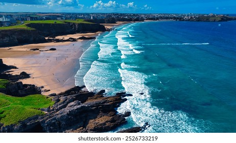 Aerial view of a beautiful beach with golden sand and turquoise waves. At Porth Beach, Cornwall, UK. - Powered by Shutterstock