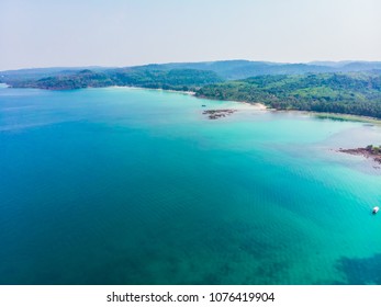 Aerial view of beautiful beach and sea with coconut palm tree on blue sky in the paradise island