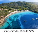 Aerial view of the beautiful beach and turquoise sea at Tsougrias island, Skiathos, Sporades, Greece