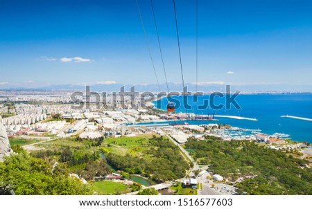 Aerial view of beautiful blue Gulf of Antalya and popular seaside resort city Antalya, Turkey. Tunektepe Cable Car is aerial lift serving peak of Tunek Tepe hill. Stock photo © 