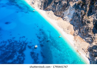 Aerial view of the beautiful coast of Kefalonia island, Greece, with turquoise sea, little beaches and a sailboat moored over the crystal clean water - Shutterstock ID 1790441747
