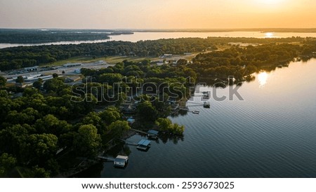 An aerial view of the beautiful Grand Lake Oklahoma at sunset, with the lake's waters reflecting the hues of the setting sun