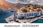 Aerial view of the beautiful greek island of Symi (Simi) with colourful houses and small boats. Greece, Symi island, view of the town of Symi (near Rhodes), Dodecanese.