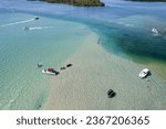 An aerial view of the beautiful Haulover Sandbar in Miami with ships on a bright sunny day