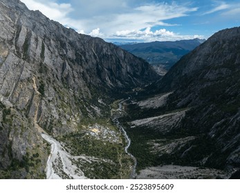 Aerial view of beautiful high altitude forest canyon and snow capped mountain landscape - Powered by Shutterstock