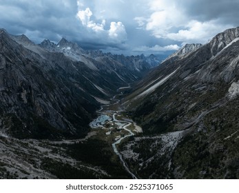 Aerial view of beautiful high altitude forest canyon and snow capped mountain landscape - Powered by Shutterstock