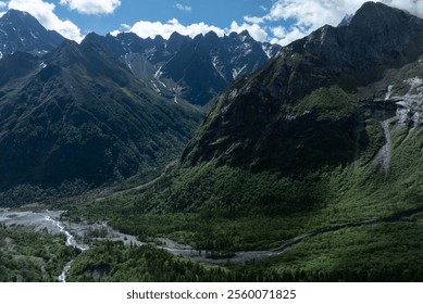 Aerial view of beautiful high altitude snow capped mountain and forest landscape - Powered by Shutterstock