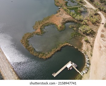 An aerial view of the beautiful Lake Palmdale with boats and the soil road on the lakeside