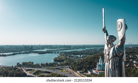 Aerial view to the  Beautiful landscape city Kiev with a Dnepr river. Top view to the Motherland statue in the Kiev. The well-known landmarks in Kyiv. Historical monument of Soviet union.  - Shutterstock ID 2120113334