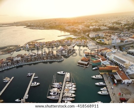Aerial view of the beautiful Marina in Limassol city in Cyprus,beach,boats,piers,villas and commercial area.A modern,high end,newly developed space with docked yachts and for a waterfront promenade. 