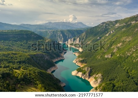 Aerial view of Beautiful Piva river canyon with reservoir Piva Lake (Pivsko Jezero) summer view in Montenegro. Nature travel background.