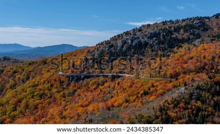Aerial view of beautiful rock formations along the North Carolina mountains as the leaves start to change during the first part of fall.