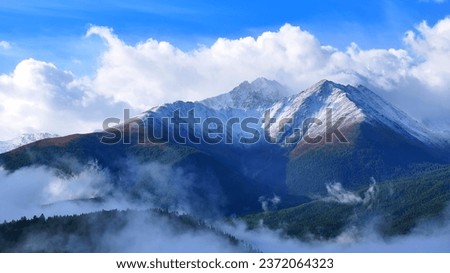 Aerial view of a beautiful snow-capped Alatau mountains in East Kazakhstan