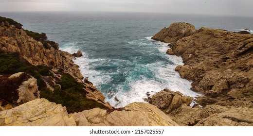 An Aerial View Of A Beautiful Stormy Sea Crashing On The Boulders On The Mallorca Coast In Spain