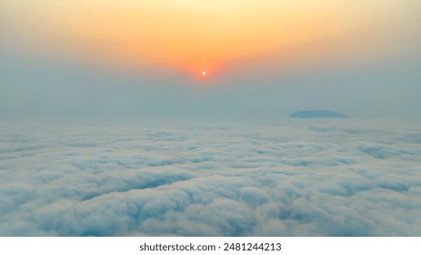 Aerial view of a beautiful sunset as seen from the plane, view above the clouds at an altitude of 800 meters in Long Coc, Vietnam - Powered by Shutterstock