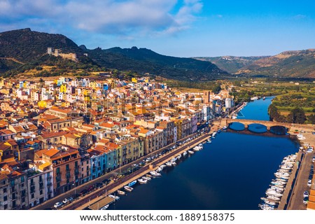 Aerial view of the beautiful village of Bosa with colored houses and a medieval castle. Bosa is located in the north-wesh of Sardinia, Italy. Aerial view of colorful houses in Bosa village, Sardegna.