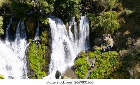 Aerial view of a beautiful waterfall cascading down rocky cliffs