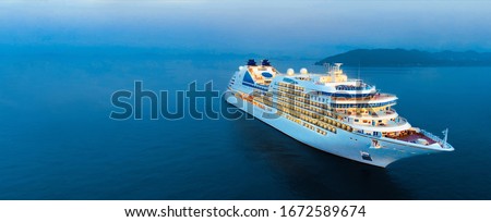 Aerial view of beautiful white cruise ship above luxury cruise in the ocean sea at early in the morning time concept smart tourism travel on holiday take a vacation time on summer.  forwarder mast