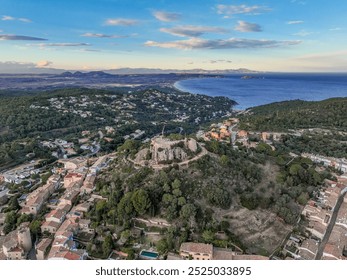 Aerial view of Begur Castle, perched atop a hill in Catalonia, Spain. Surrounded by lush greenery and stunning coastal scenery, this historic gem offers breathtaking panoramic views! 🏰🌅 - Powered by Shutterstock