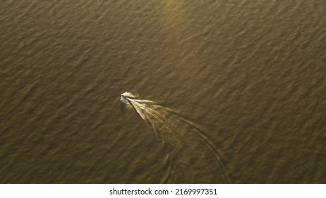 Aerial View Behind Jetski On Lake During Sunset