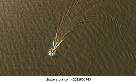 Aerial View Behind Jetski On Lake During Sunset In South America