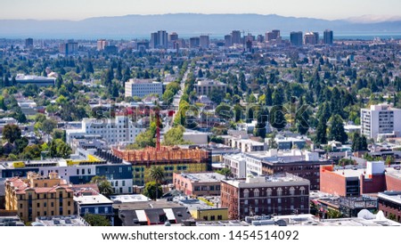 Aerial view of Berkeley and north Oakland on a sunny day; downtown Oakland in the background; San Francisco bay, California