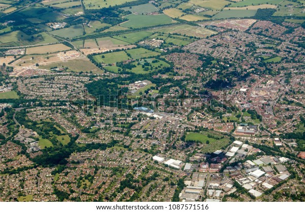 Aerial view of the Berkshire town\
of Wokingham, seen on a sunny summer day.  The blue structure of\
the railway station\'s multi-story car park is at the\
centre.