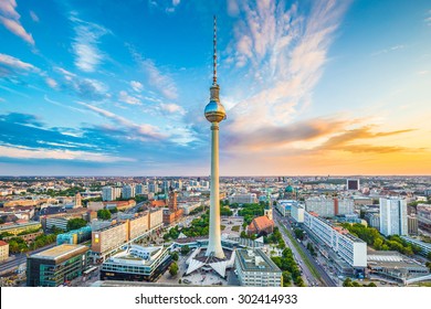 Aerial view of Berlin skyline with famous TV tower at Alexanderplatz and dramatic cloudscape at sunset, Germany