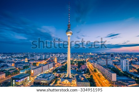 Aerial view of Berlin skyline with famous TV tower at Alexanderplatz and dramatic clouds in twilight during blue hour at dusk, Germany
