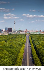 Aerial view of Berlin skyline panorama with Grosser Tiergarten public park on a sunny day with blue sky and clouds in summer seen from famous Berlin Victory Column (Berliner Siegessaeule), Germany