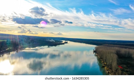 Aerial View Of Big Blue River, Winter Forest And Beautiful Blue Sky.