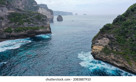 Aerial View Of Big Cliff On Coast, Dron Fly Through Hole In Cliff. Zoom-out Of Giant Rock In Golden Bay To Wide Landscape.