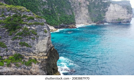 Aerial View Of Big Cliff On Coast, Dron Fly Through Hole In Cliff. Zoom-out Of Giant Rock In Golden Bay To Wide Landscape.