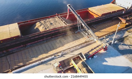 Aerial view of big grain elevators on the sea. Loading of grain on ship. Port Ukraine. Cargo ship