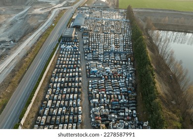 Aerial view of big parking lot of junkyard with rows of discarded broken cars. Recycling of old vehicles - Shutterstock ID 2278587991