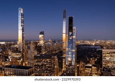 Aerial view of Billionaires' Row skyscrapers in Midtown Manhattan at dusk with view of Central Park. Last rays of sun reflect on the supertall buildings. New York City - Shutterstock ID 2329970393