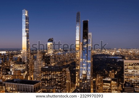 Aerial view of Billionaires' Row skyscrapers in Midtown Manhattan at dusk with view of Central Park. Last rays of sun reflect on the supertall buildings. New York City
