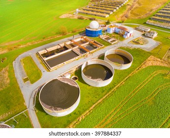 Aerial view to biogas plant from pig farm in green fields. Renewable energy from biomass. Modern agriculture in Czech Republic and European Union. 