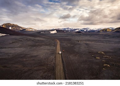 Aerial view of black volcanic desert on wilderness with 4x4 vehicle car parked in Landmannalaugar at Icelandic highlands