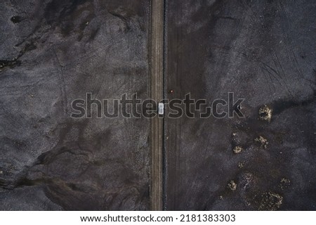 Aerial view of black volcanic desert on wilderness with 4x4 vehicle car parked in Landmannalaugar at Icelandic highlands