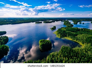Aerial View Of Blue Lakes And Green Forests On A Sunny Summer Day In Finland. Drone Photography From Above