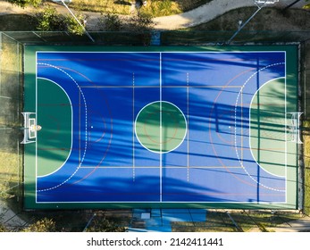 Aerial View Of Blue Multi-sport Court In The Park. Used To Practice Football, Basketball Or Volleyball. Top View. Sunny Day. Sunset. Drone Photo.