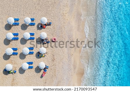Similar – Image, Stock Photo Beach chair, sandy beach, sea and sun breaks through clouds with its rays