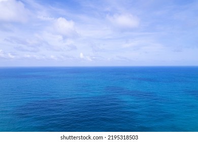 Aerial View Of A Blue Sea Water Background And Sun Reflections. Aerial Flying Drone View And Shadow Clouds On Sea Surface,water Texture On Ocean, Aerial Photography. Birds Eye View. Sea, Sky, Clouds