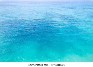 Aerial View Of A Blue Sea Water Background And Sun Reflections. Aerial Flying Drone View And Shadow Clouds On Sea Surface,water Texture On Ocean, Aerial Photography. Birds Eye View. Sea