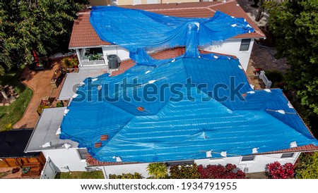 Aerial view of the blue tarp roof